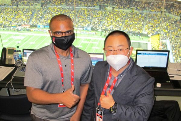 Master's students David Hayden and David Song stand together at Lucas Oil Stadium on Dec. 4, 2021
