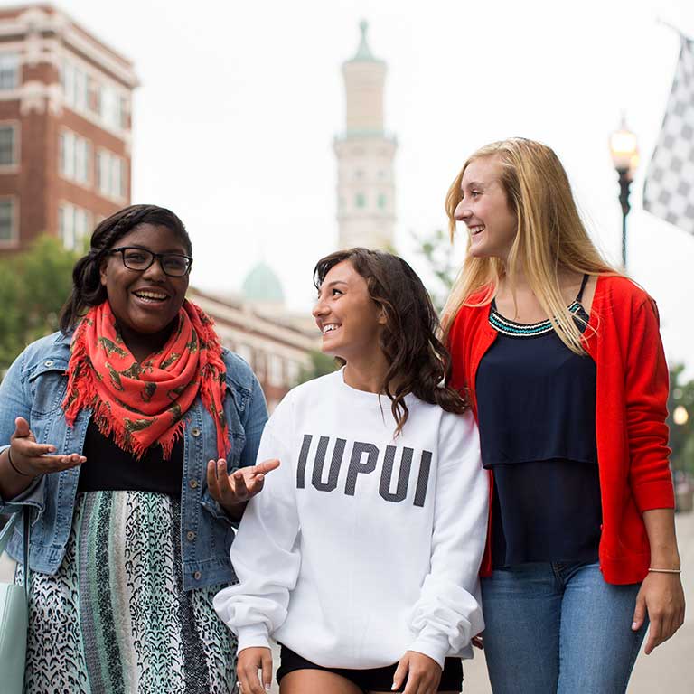 Female students talk and walk in downtown Indianapolis.