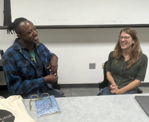 Image of Johnathan Square (left) in a discussion with Professor Dr. Laura Holzman (right).