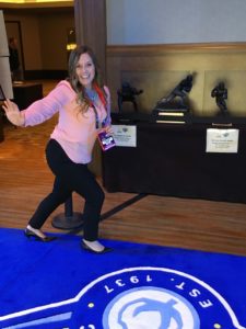 Jessica Wimsatt poses with the Heisman Trophy at the Goodyear Cotton Bowl Classic in Dallas.