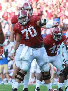 Alabama center Ryan Kelly points out coverage during an Alabama home game.